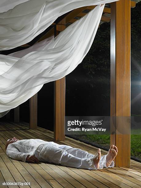 man sleeping on wooden floor - curtain blowing stock pictures, royalty-free photos & images