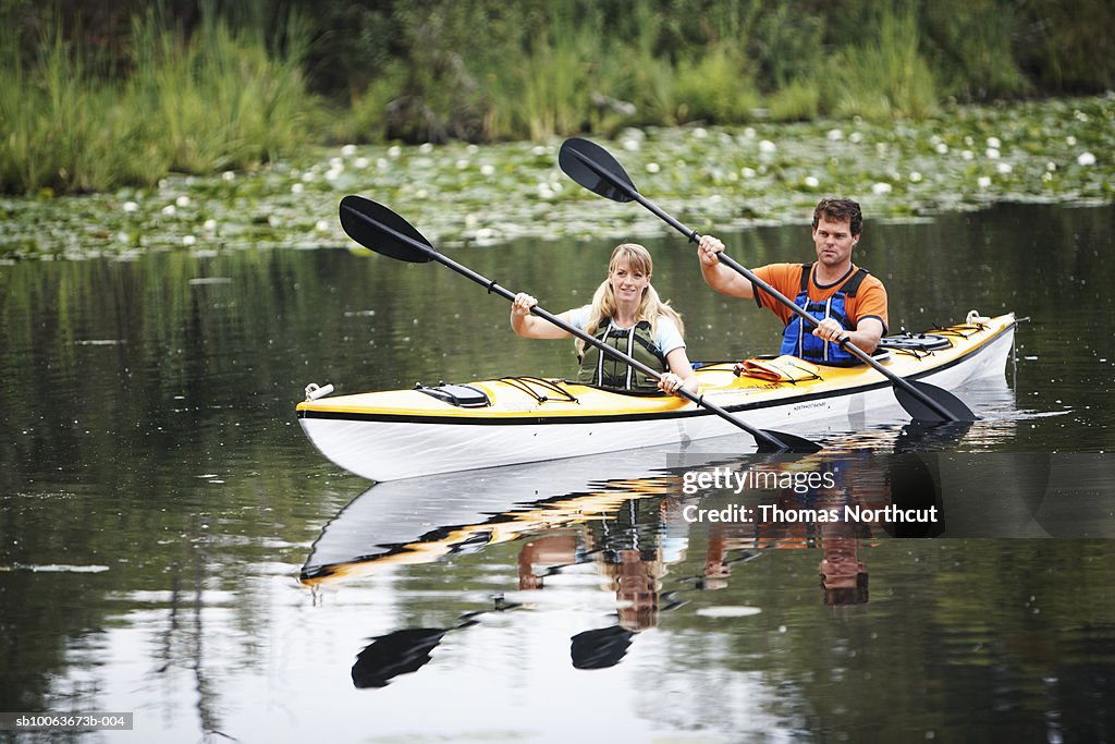 Couple canoeing on lake, Seattle, Washington, USA