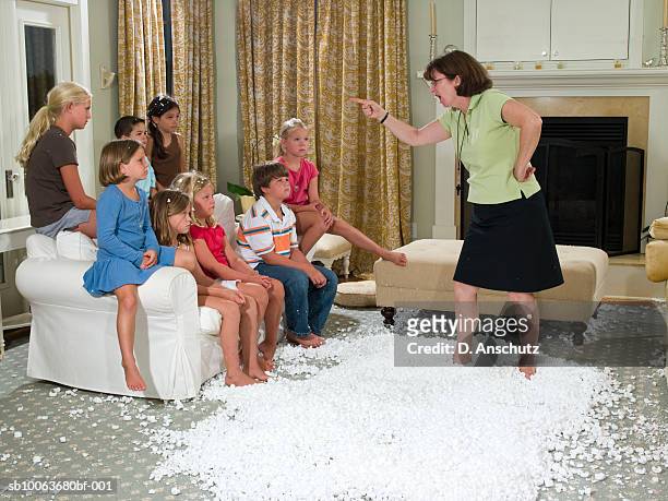 mother scolding children (3-11), standing in pile of packing peanut in living room - kids mess carpet stock pictures, royalty-free photos & images