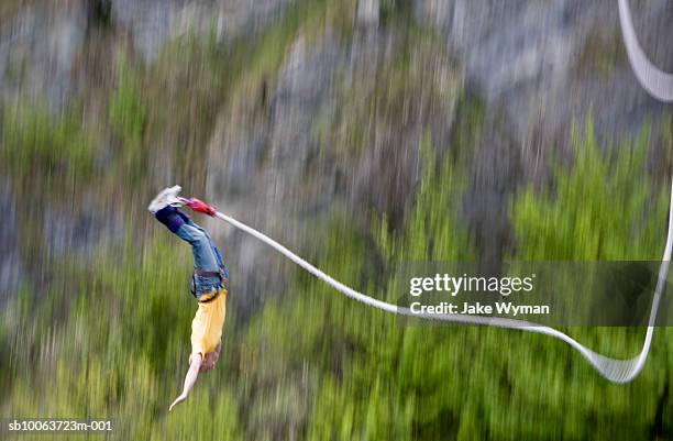 man bungee jumping, blurred motion - bungee stock pictures, royalty-free photos & images