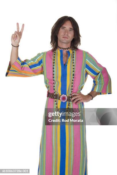 man wearing robe making peace sign, portrait - túnica fotografías e imágenes de stock