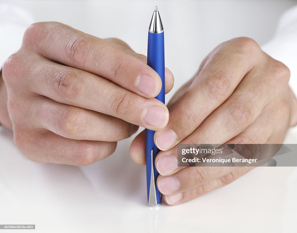 Man holding pen, close-up