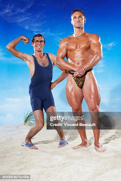 man flexing muscles next to body builder - a fool stock pictures, royalty-free photos & images
