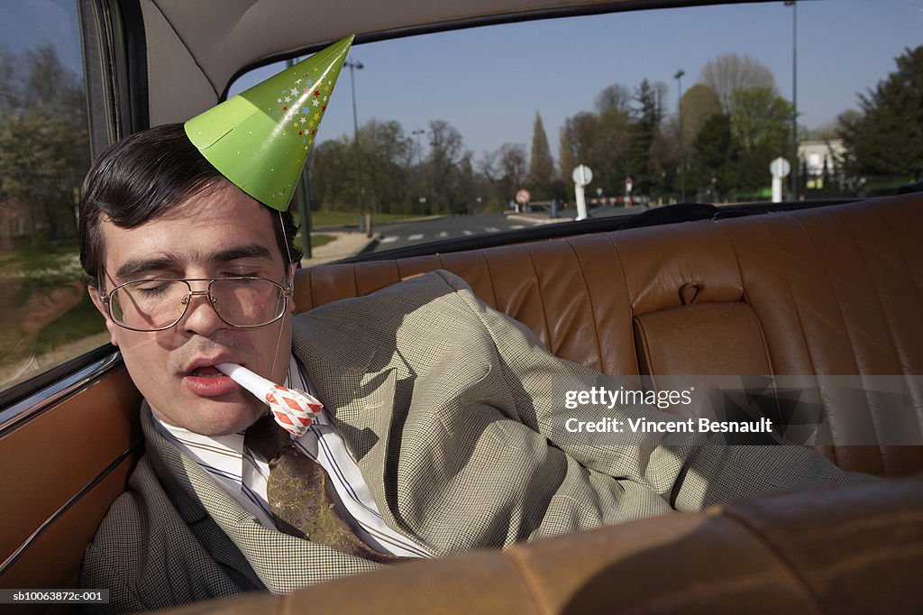 Drunk man asleep on back seat of car