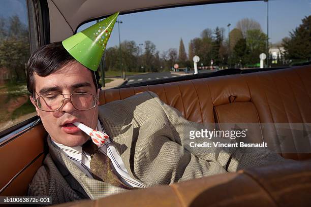drunk man asleep on back seat of car - drunk stockfoto's en -beelden
