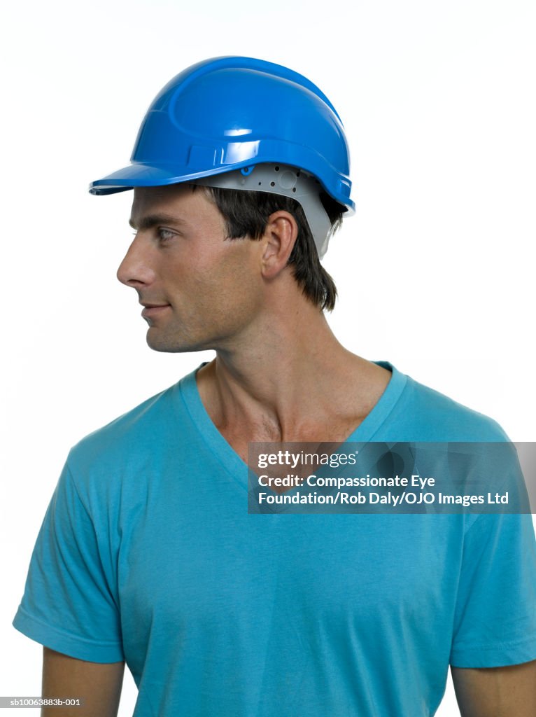 Man wearing hard hat, turning to side