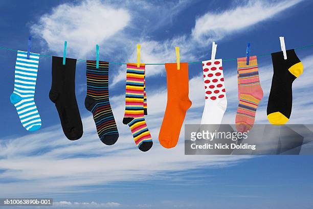 various socks hanging on washing line - clothesline stock pictures, royalty-free photos & images