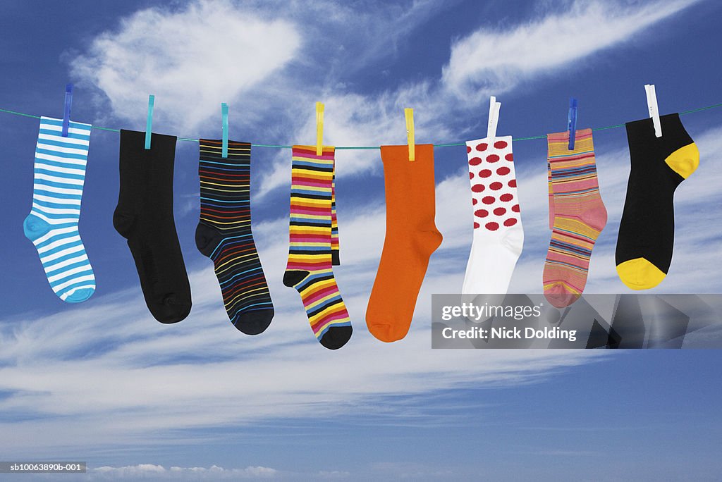 Various socks hanging on washing line