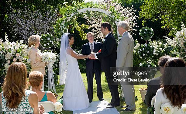 bride and groom saying vows at wedding - outdoor wedding stock pictures, royalty-free photos & images