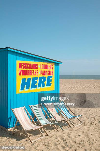deckchairs next to hut on beach - advertising deckchair stock pictures, royalty-free photos & images
