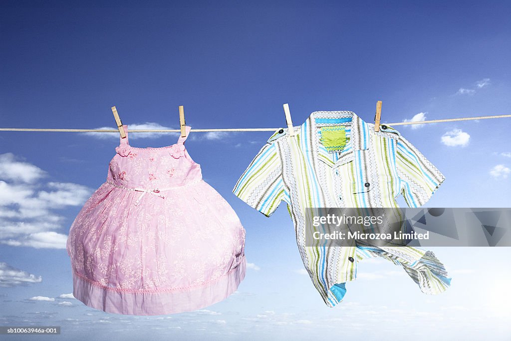 Children clothes hanging on washing line, low angle view