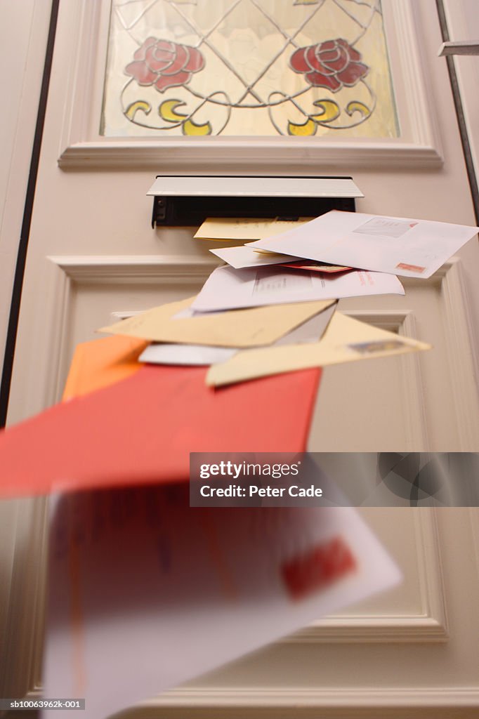 Mail falling from letterbox, low angle view