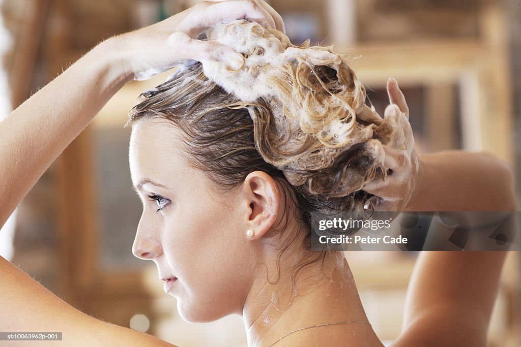 Young woman washing hair, close-up