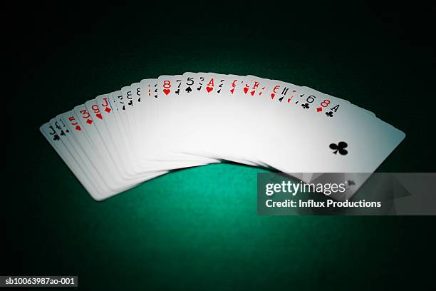 playing cards spread out on green felt - gambling table stock pictures, royalty-free photos & images