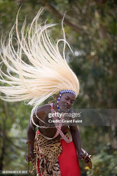 young man in costume performing traditional watusi dance - rwanda - fotografias e filmes do acervo