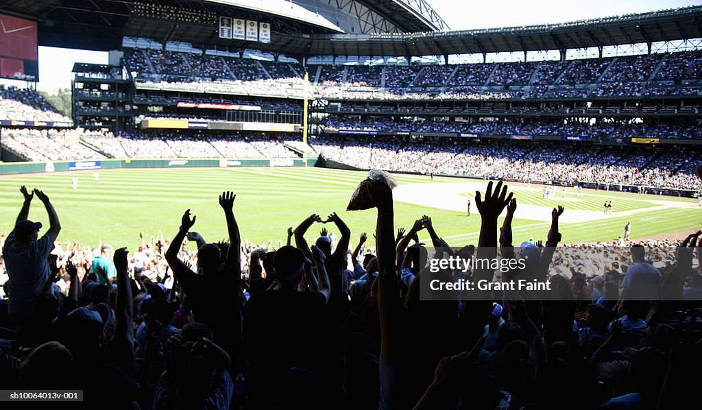 Crowd at stadium cheering during baseball match