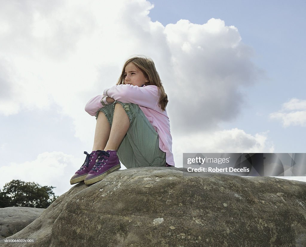 Girl Looking Over Rocks Girl Sitting On Rock Looking At View High-Res Stock Photo - Getty Images