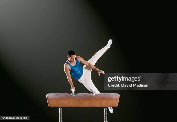 male gymnast performing on pommel horse - pommel horse bildbanksfoton och bilder