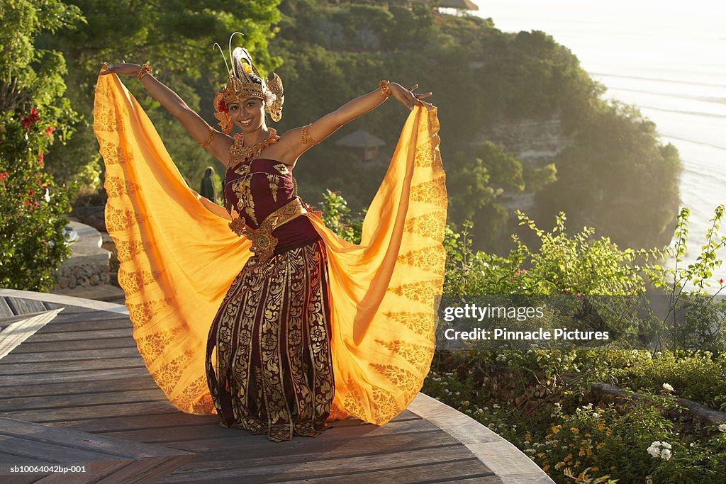 Indonesian dancer performing on cliff