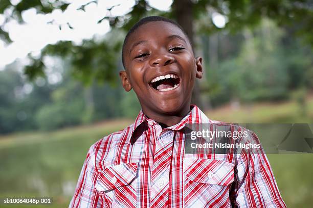 boy (8-11) by river side, laughing, portrait - child mouth open stock pictures, royalty-free photos & images