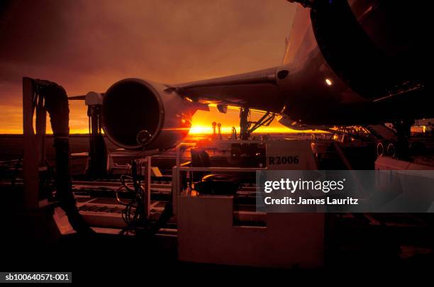 unloading of airplane at sunset - boeing 767 stock pictures, royalty-free photos & images