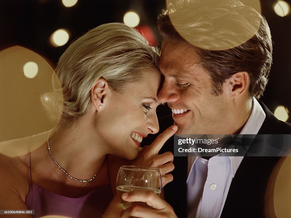 Couple in evening wear having dinner in restaurant, close-up