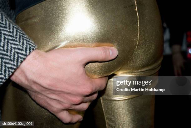 man gripping woman's buttock, mid section, close-up of hand - female asses stock pictures, royalty-free photos & images