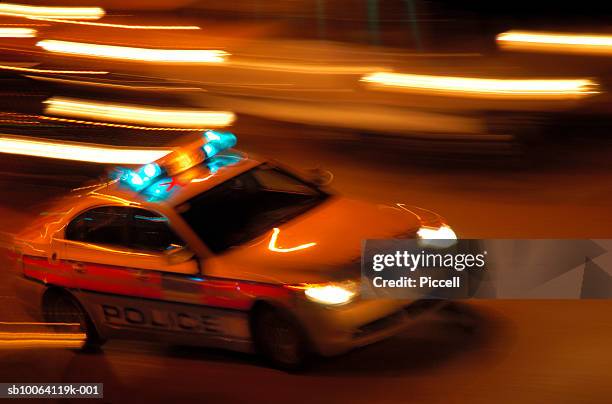 police car at night, blurred motion - london police car stock pictures, royalty-free photos & images
