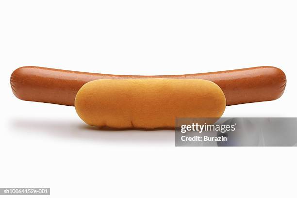 oversized frankfurter on bun, close-up, studio shot - hot dog bun stock pictures, royalty-free photos & images
