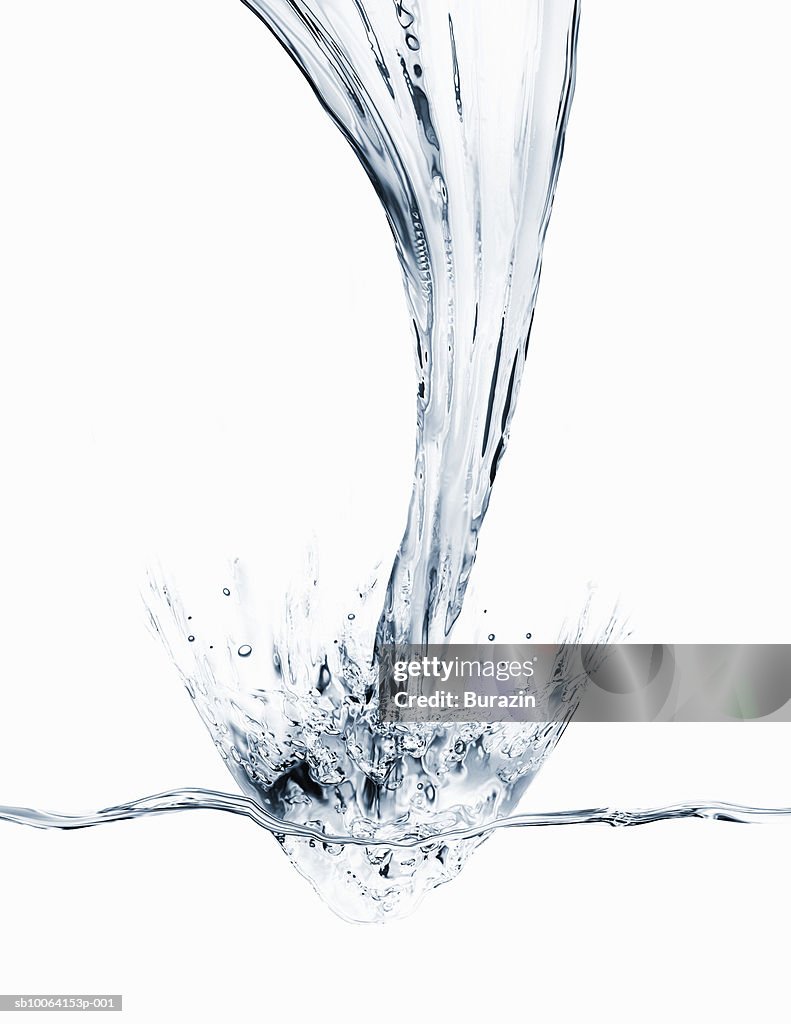 Water pouring and splashing on white background