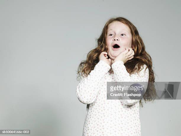 girl (8-9) with hands on face, mouth open - child shock studio stock pictures, royalty-free photos & images