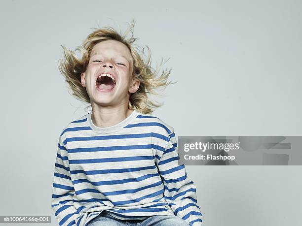 boy (8-9) laughing, mouth open, close-up - somente crianças imagens e fotografias de stock