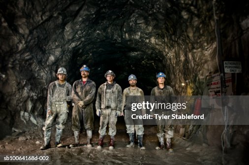 Coal miners in front of mine shaft