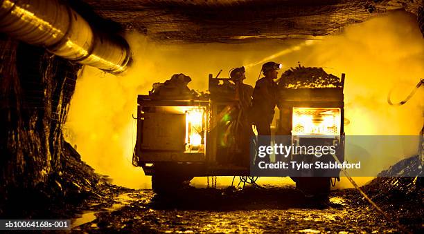 two coal miners in mine shaft - kohlengrube stock-fotos und bilder