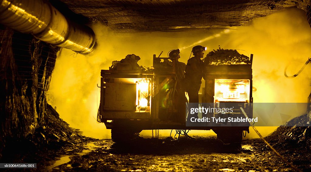 Two coal miners in mine shaft