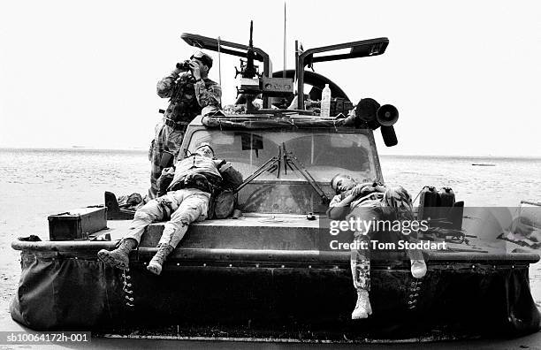 Marines from 539 Assault Squadron rest on a hovercraft on the Al Faw penninsula, Iraq., Under cover of darkness on March 21 539 Assault Squadron...