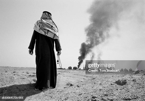 , An Iraqi watches a burning gas and petrochemical processing plant in the oil rich Az Zubayr area of Southern Iraq. , Iraq possesses the world's...