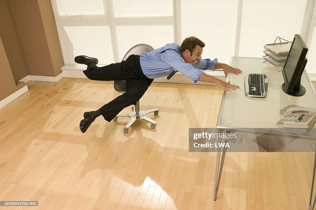 Businessman Falling From Chair Laughing Elevated View High-Res Stock ...