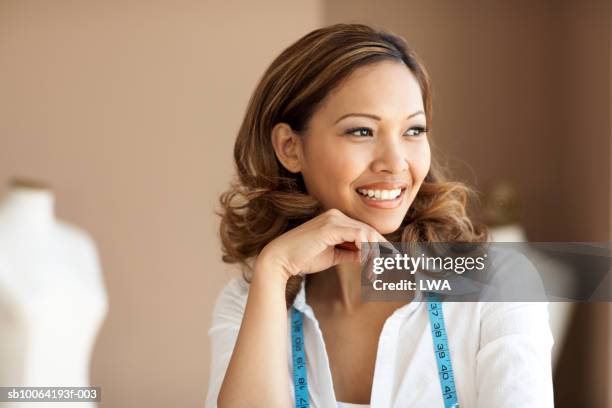 woman with tape measure, looking away, smiling, close-up - mannequin blonde stockfoto's en -beelden