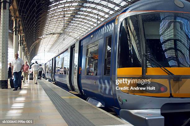 passengers at subway station - public transport stock-fotos und bilder