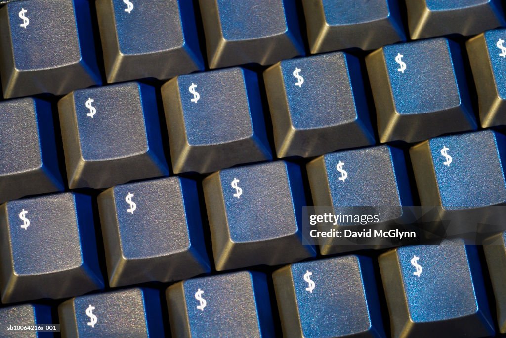 Black computer keyboard with dollar symbol on every key, close-up