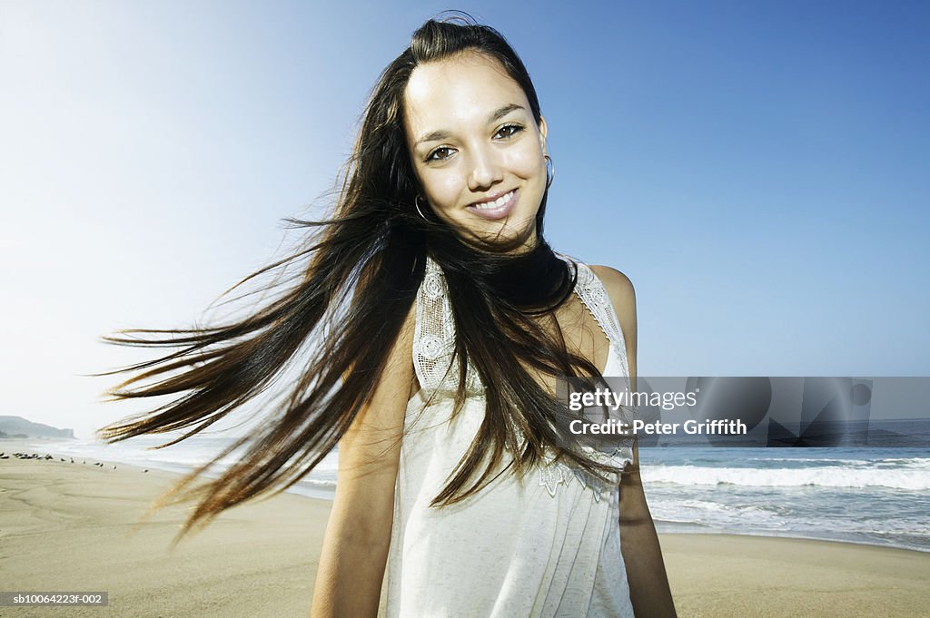Teenage girl (16-17) on beach, portrait
