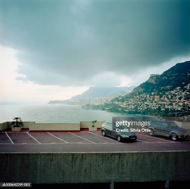 cars in parking lot with monaco harbour - monaco cars stock pictures, royalty-free photos & images