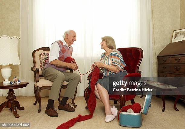 senior couple knitting in living room - man knitting stock pictures, royalty-free photos & images