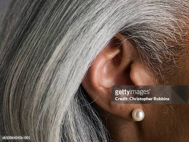 macro shot of senior woman's ear - ear stockfoto's en -beelden