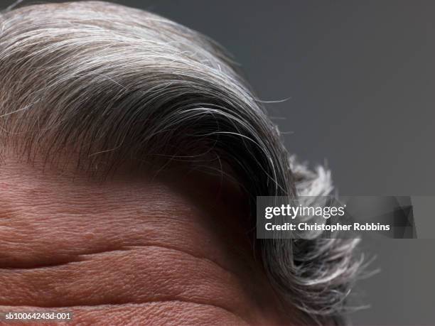 macro shot of senior man's hair and forehead - grey hair man stock pictures, royalty-free photos & images