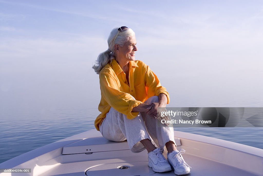 Senior woman sitting in boat