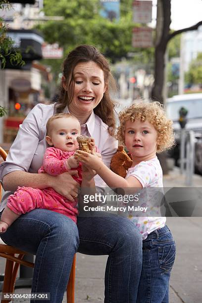 young woman with baby girl (9 months) and young girl (2-3) holding ice cream - family ice center stock pictures, royalty-free photos & images