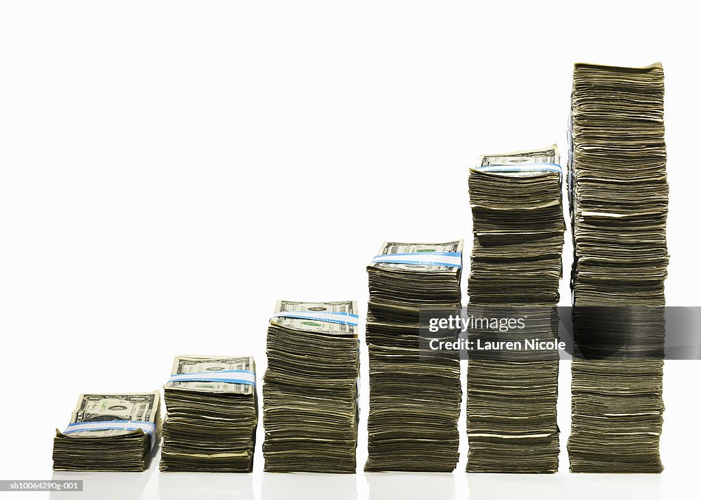 Stacks of US currency in ascending graph pattern