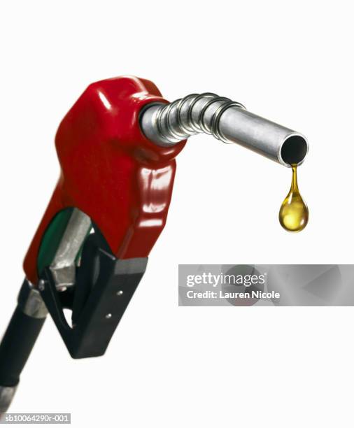 gasoline nozzle with drop of oil, close-up - pompa foto e immagini stock